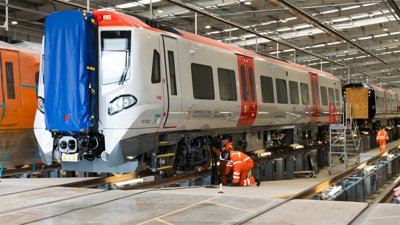 Workers inspecting TfW brand-new fleet at the factory