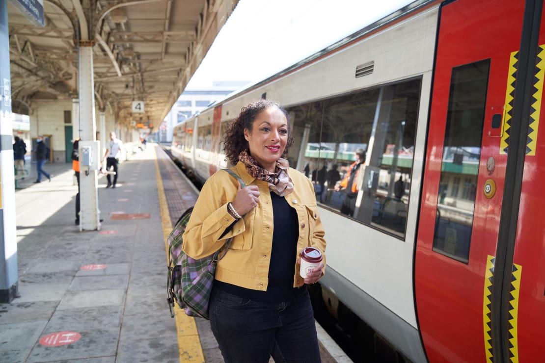 A woman waiting to board a Transport for Wales train