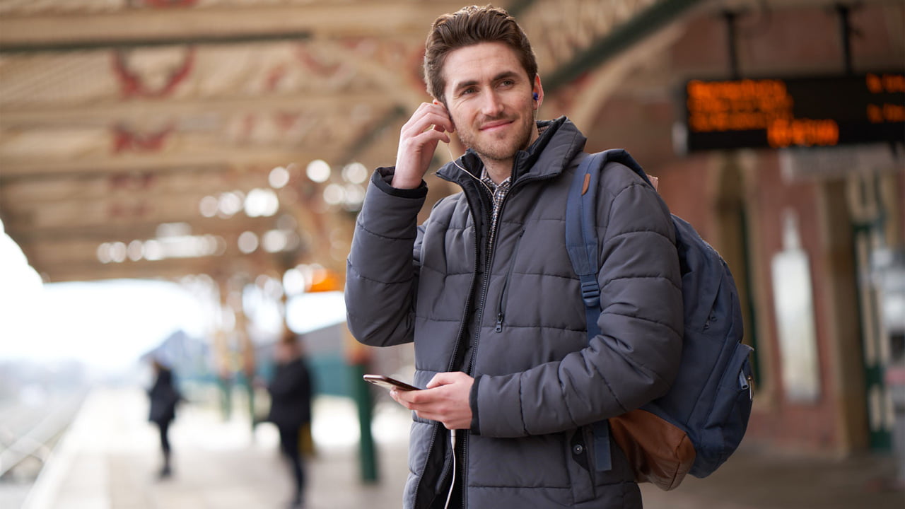 A person waiting on a railway station platform